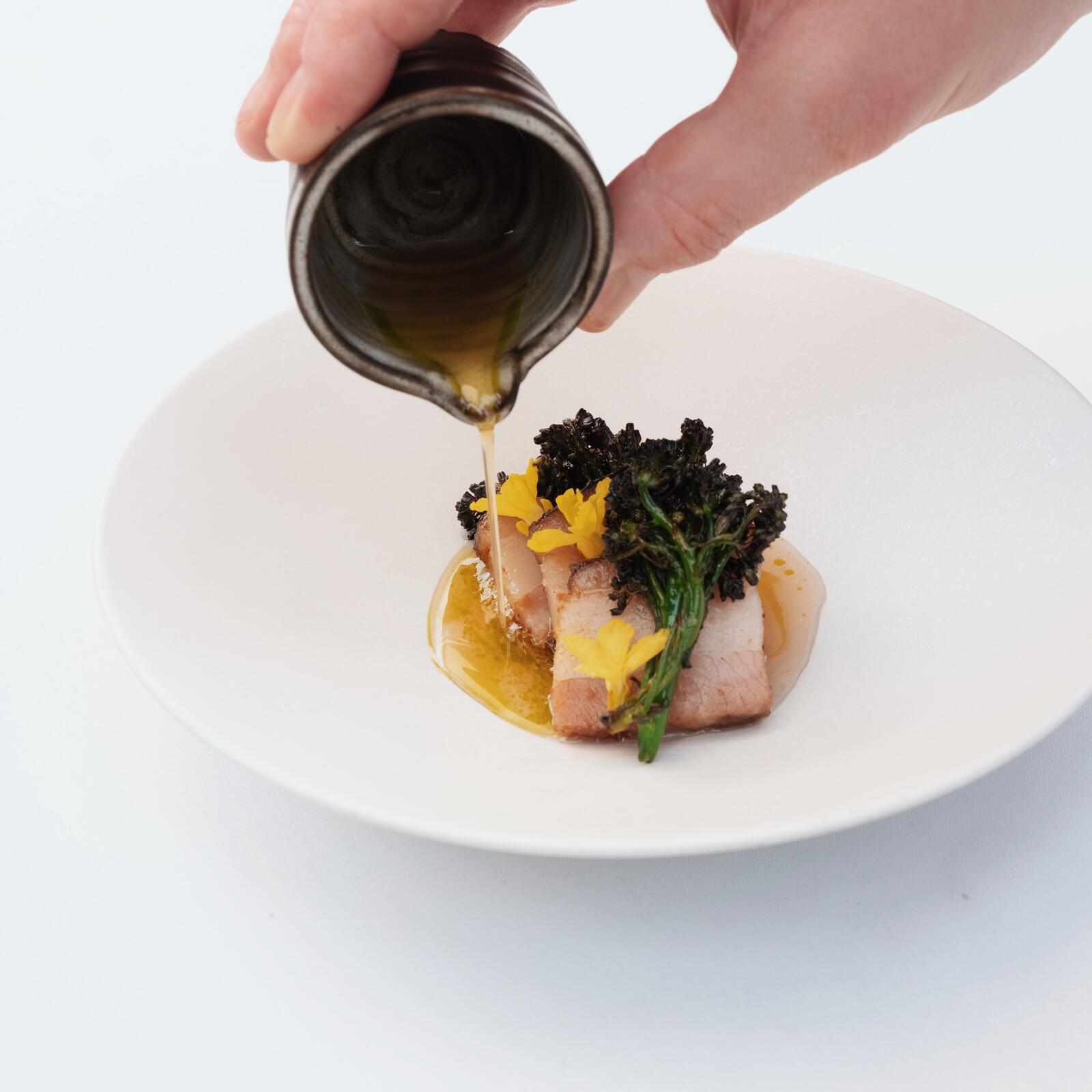 Charred pork belly with pear consumé